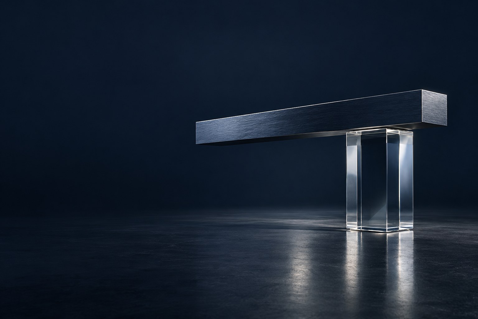 A brushed navy steel cantilever rests in deliberate balance on a clear glass structure.