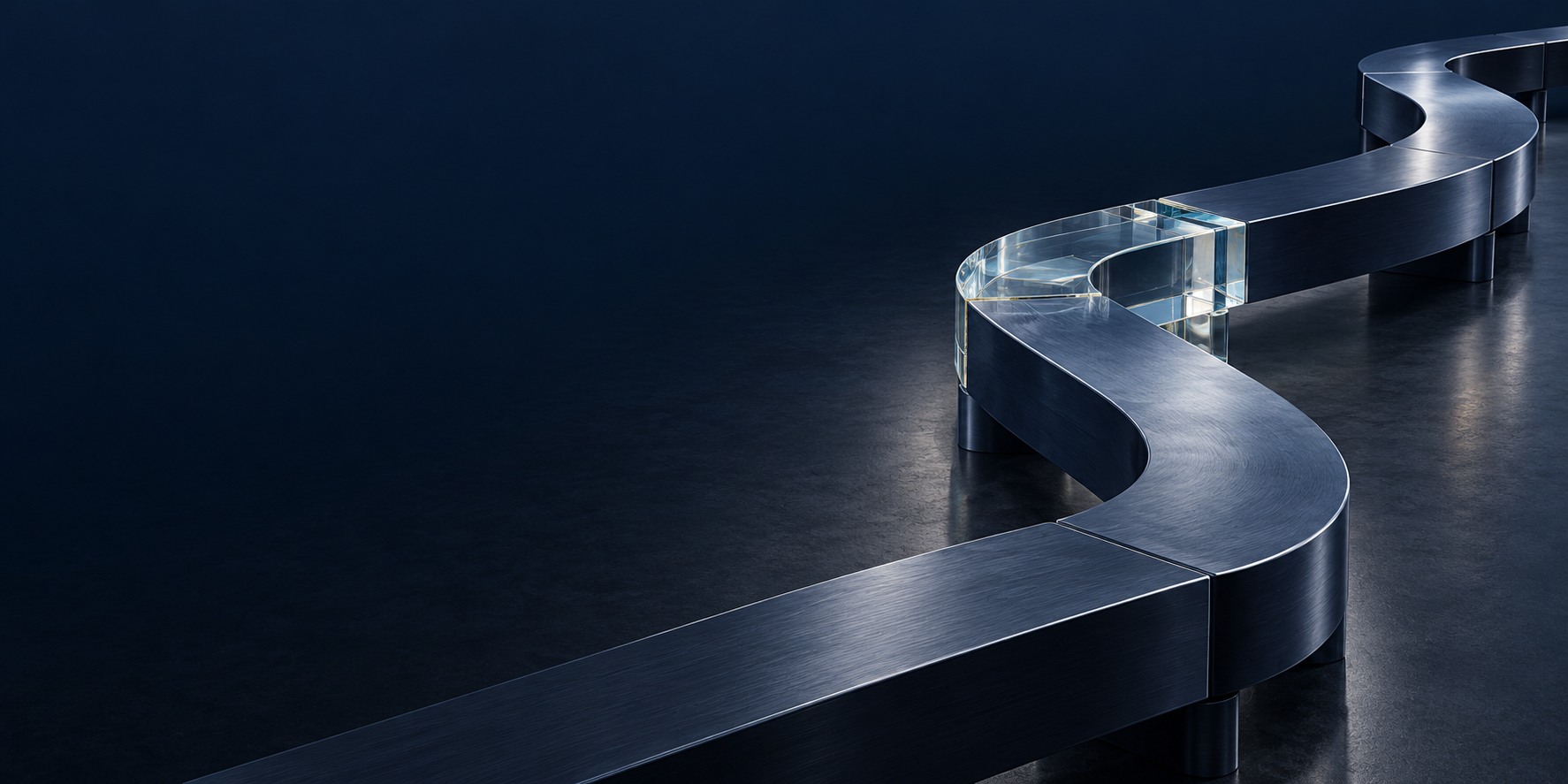 Steel segments and a clear glass joint maintain a connected architectural route as its direction changes.