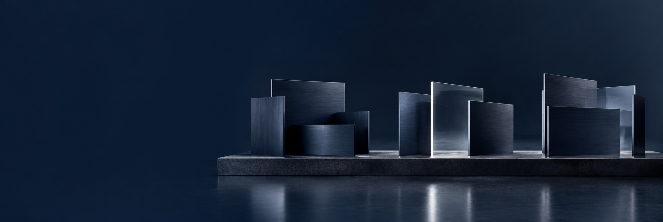 Navy steel partitions are rearranged into three architectural spaces, with a clear glass plane opening a new perspective.